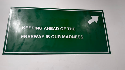 FREEWAY SIGN : Keeping ahead of the freeway is our madness